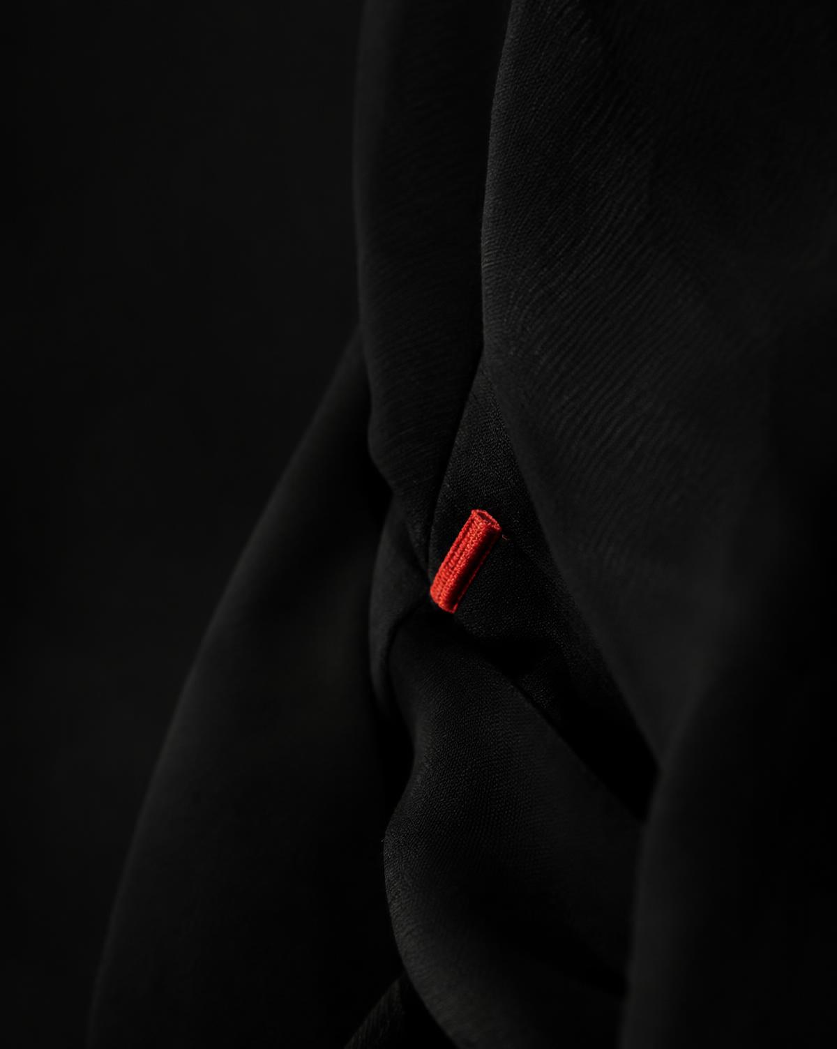 Black garment with a small red stitched tab