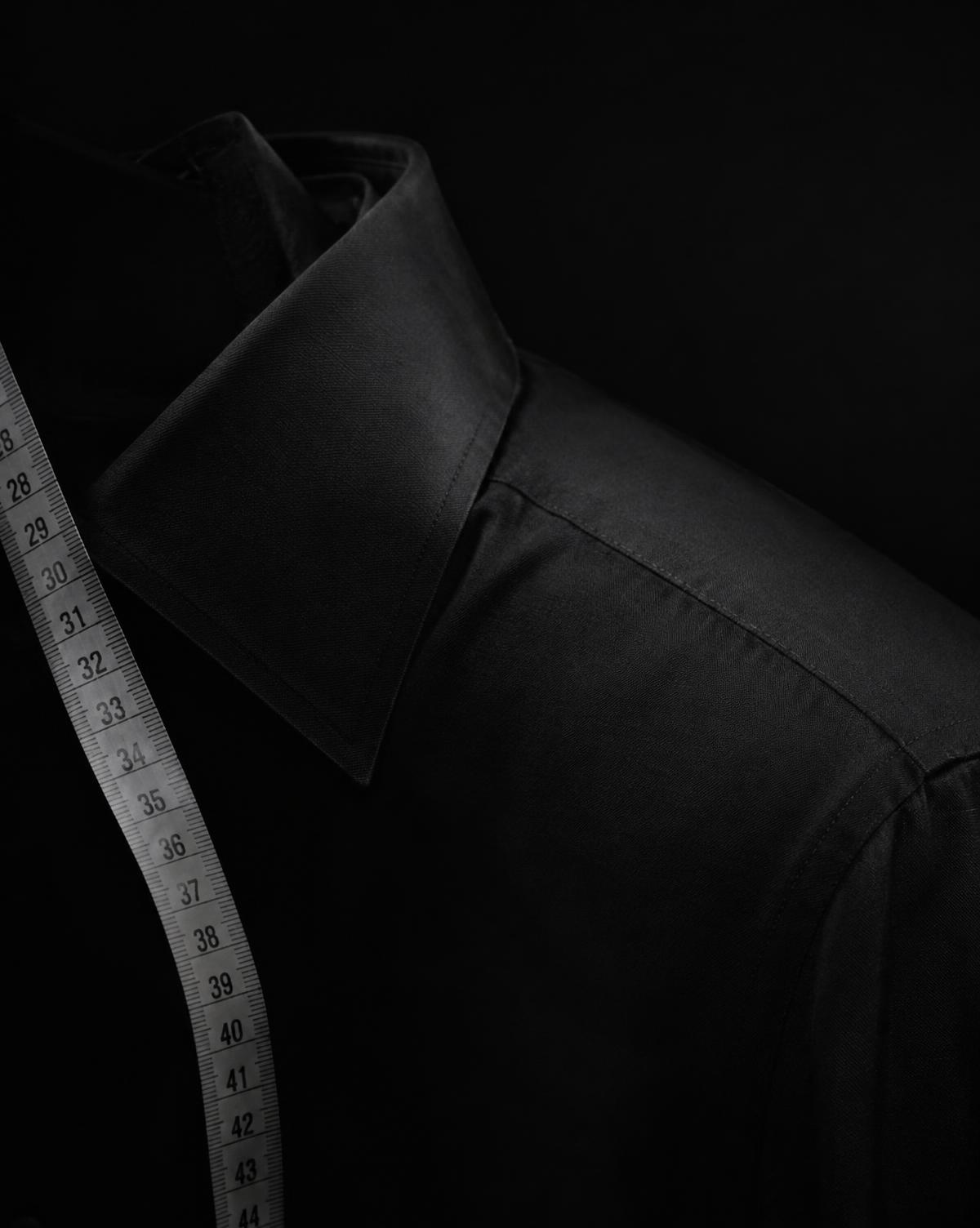 Black shirt collar and shoulder with a measuring tape