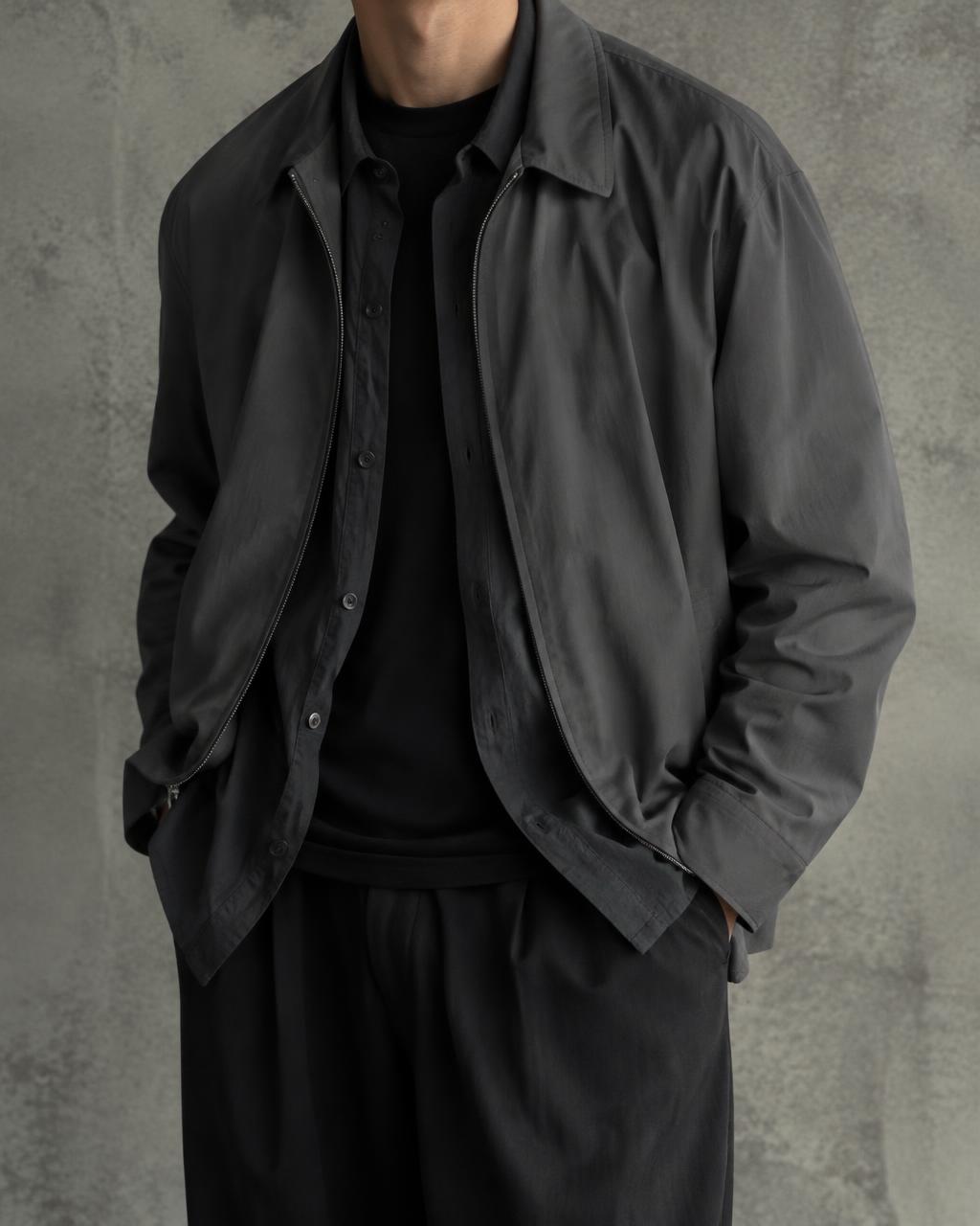 A black T-shirt under a charcoal overshirt under a dark grey jacket