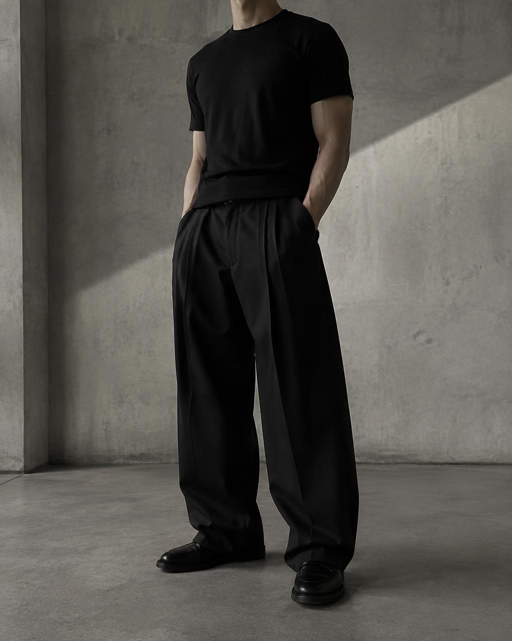 A fitted black T-shirt with wide relaxed black trousers