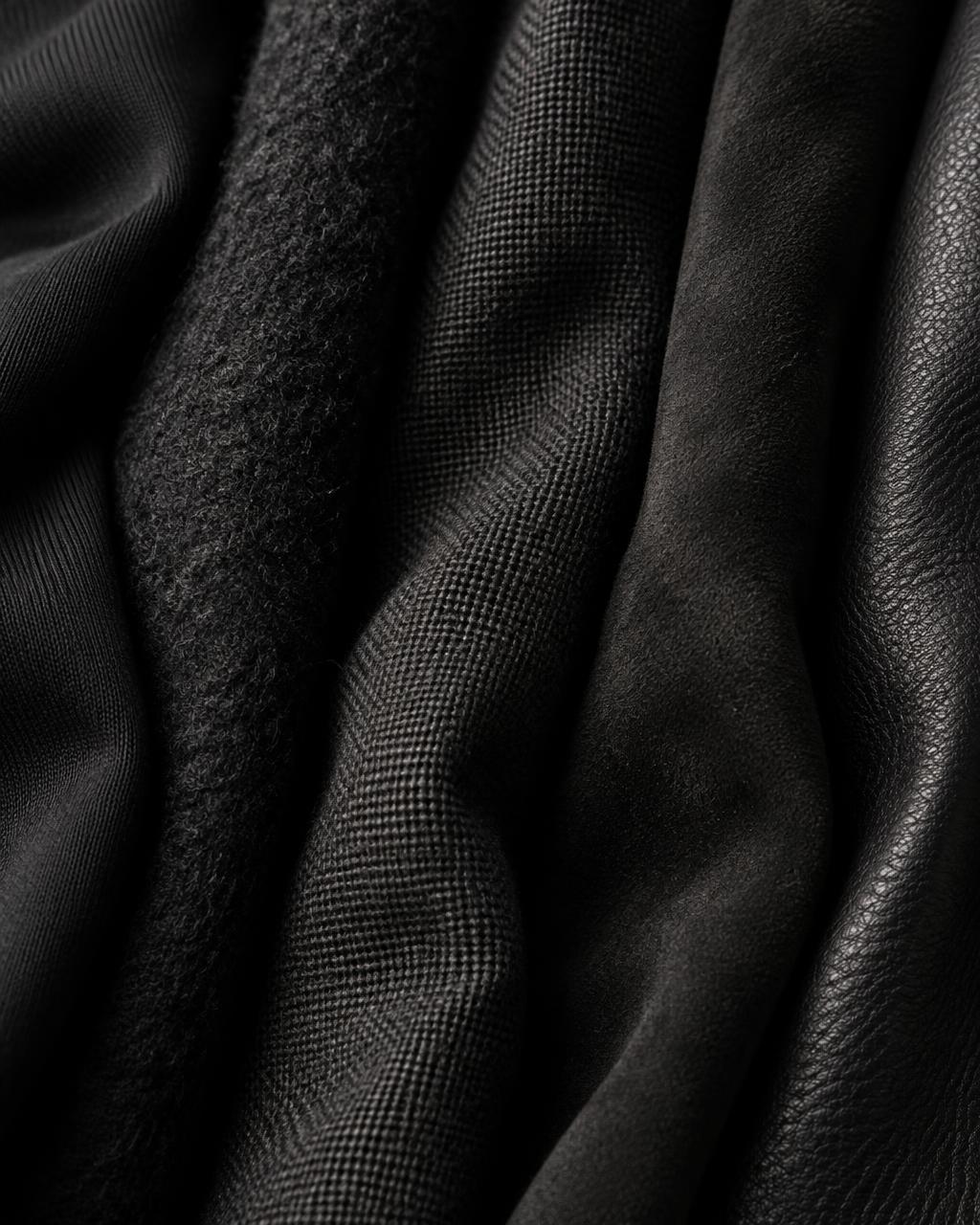 Black cotton, wool, linen, suede and leather textures side by side