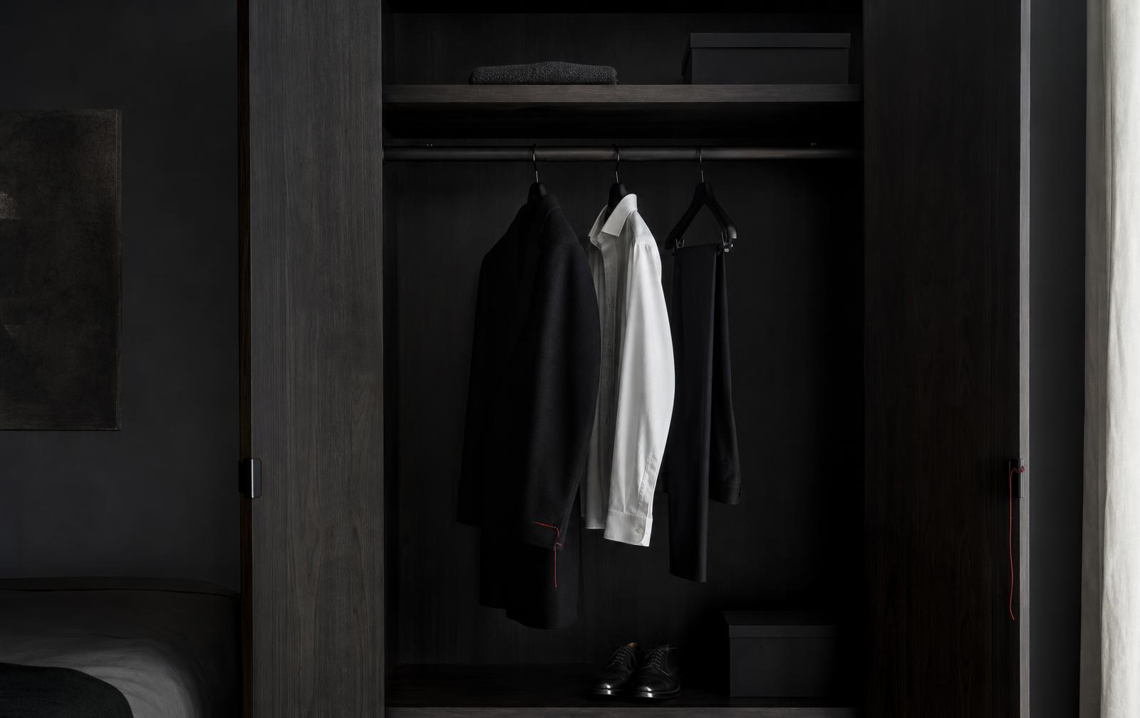 Sparse masculine wardrobe with only a few essential black and white garments